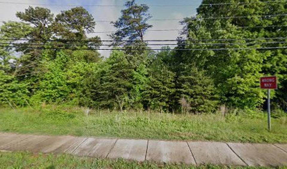Neighbors are upset about the potential loss of numerous tall trees if a four-acre boat and RV sales and service center is approved on this wooded stretch of Brawley School Road at Oak Tree Road in Mooresville near Lake Norman. Street View image from April 2023. © 2024 Google
