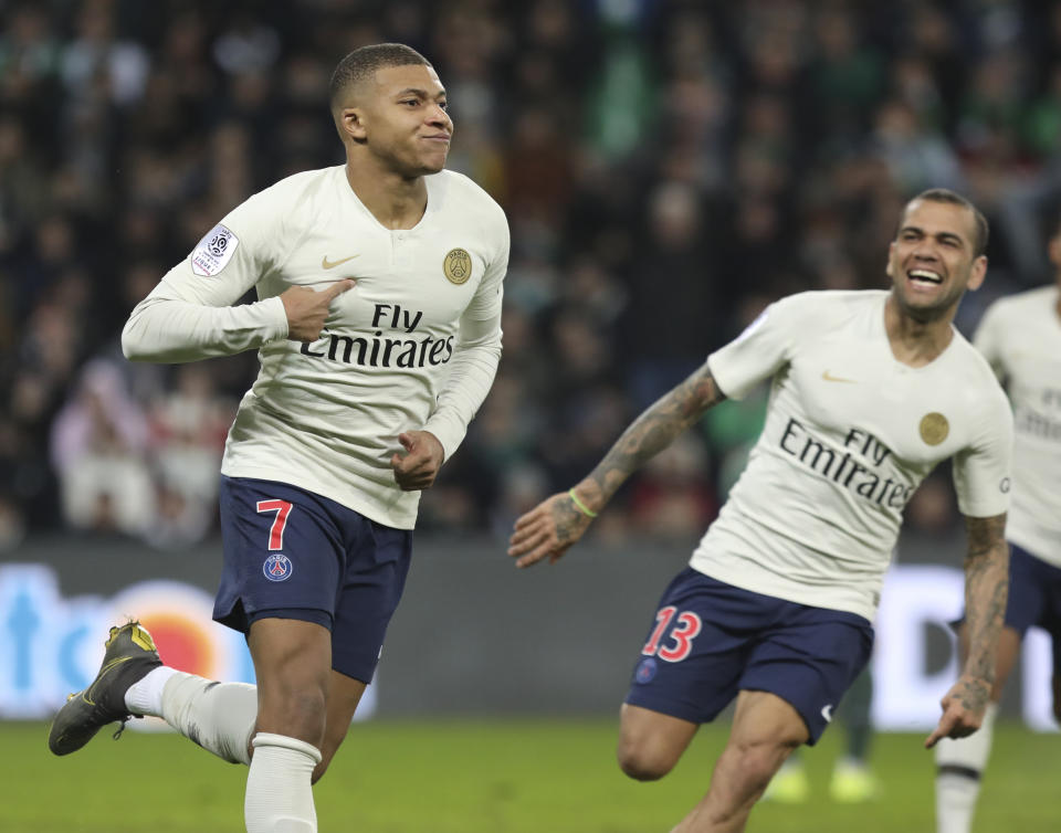 PSG forward Kylian Mbappe, left, celebrates after scoring the opening goal during the French League One soccer match between Saint-Etienne and Paris Saint-Germain, at the Geoffroy Guichard stadium, in Saint-Etienne, central France, Sunday, Feb. 17, 2019. (AP Photo/Laurent Cipriani)