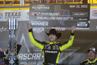 Ryan Blaney (12) hold up the first place check while celebrating in Victory Lane after winning the NASCAR All-Star auto race at Texas Motor Speedway in Fort Worth, Texas, Sunday, May 22, 2022. (AP Photo/LM Otero)