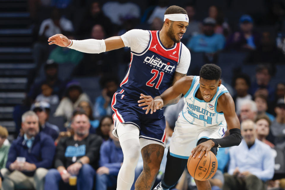 Charlotte Hornets forward Brandon Miller collides with Washington Wizards center Daniel Gafford (21) during the first half of an NBA basketball game in Charlotte, N.C., Wednesday, Nov. 8, 2023. (AP Photo/Nell Redmond)