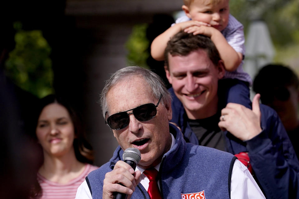 U.S. Rep. Andy Biggs, R-Ariz., speaks as republican U.S. Senate candidate Blake Masters holds his son, Rex, 2, listens, Monday, Nov. 7, 2022, in Gilbert, Ariz. (AP Photo/Matt York)