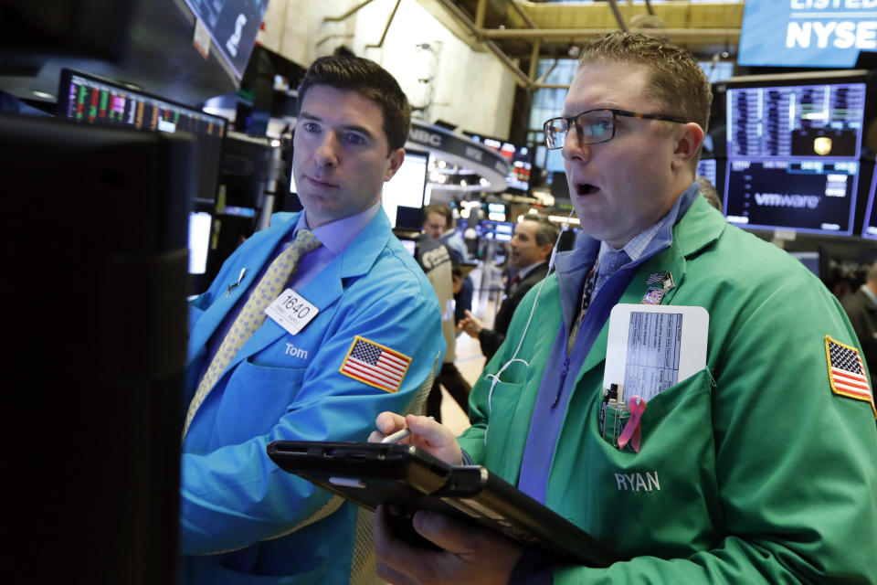Specialist Thomas McArdle, left, and trader Ryan Falvey work on the floor of the New York Stock Exchange, Monday, Jan. 14, 2019. Stocks are opening lower on Wall Street after China reported a surprise drop in exports to the U.S. last month. (AP Photo/Richard Drew)
