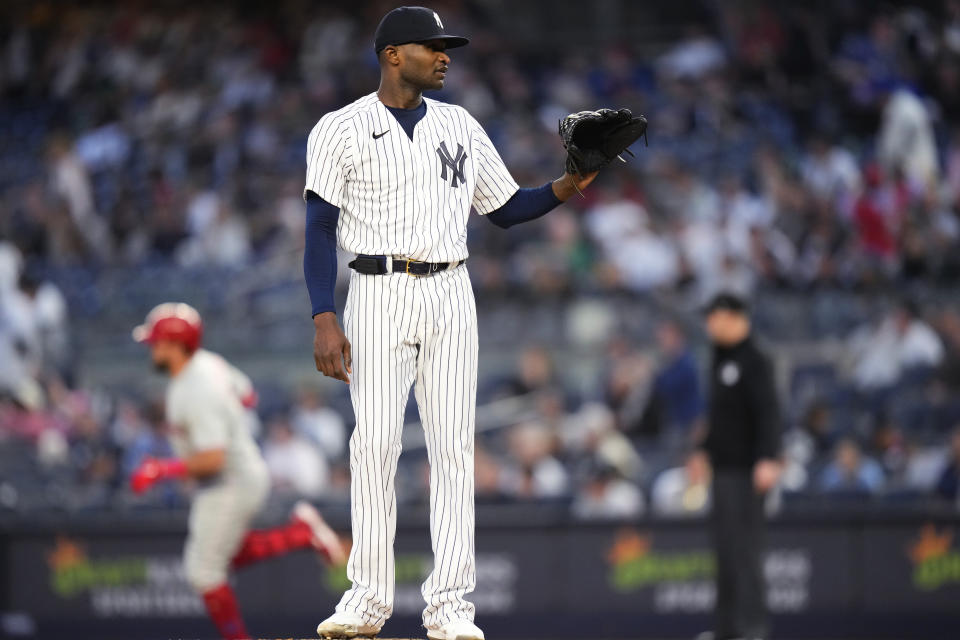 New York Yankees starting pitcher Domingo German waits for a new ball as Philadelphia Phillies' Kyle Schwarber runs the bases after hitting a home run during the first inning of a baseball game Tuesday, April 4, 2023, in New York. (AP Photo/Frank Franklin II)