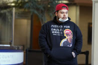 Damik Wright, the brother of Daunte Wright, waits for other family members to arrive Wednesday, Dec. 2, 2021 at the Hennepin County Government Center in Minneapolis for the third day of jury selection for former suburban Minneapolis police officer Kim Potter. Potter, who is white, is charged with manslaughter in the April 11 shooting of Wright, a 20-year-old Black motorist, following a traffic stop in Brooklyn Center. (AP Photo/Jim Mone)