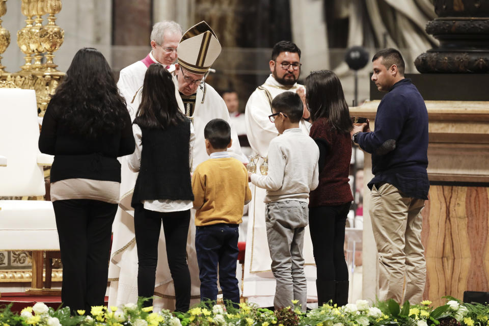 Pope Francis receives offers as he celebrates a mass in St. Peter basilica at the Vatican, Sunday, Nov. 18, 2018. Pope Francis is offering several hundred poor people , homeless, migrants, unemployed a lunch on Sunday as he celebrates the World Day of the Poor with a concrete gesture of charity in the spirit of his namesake, St. Francis of Assisi.(AP Photo/Andrew Medichini)