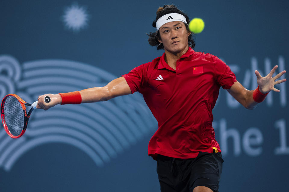 China's Zhang Zhizhen competes during the tennis men's singles final between China and Japan at the 19th Asian Games in Hangzhou, China, Saturday, Sept. 30, 2023. (AP Photo/Louise Delmotte)