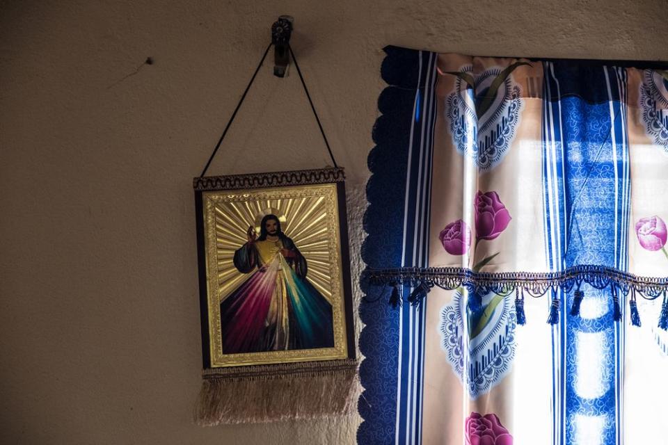 A painting of Jesus hangs on the wall of a building rented by Pastor Emmanuel Momoh, the diamond mining team sponsor.