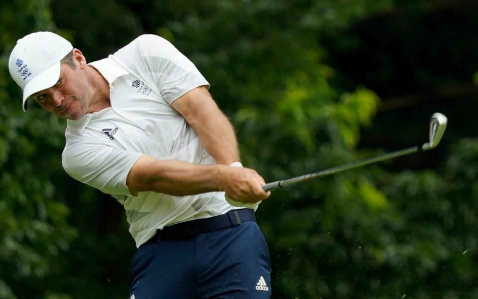 Paul Casey plays a shot from the fourth fairway during the first round of the men's golf event  - AP