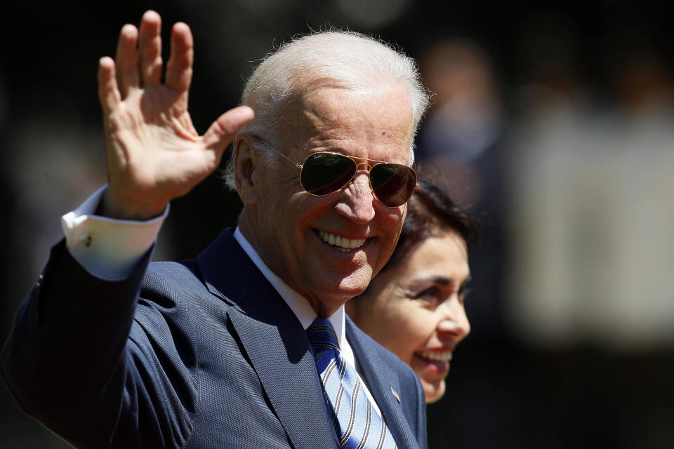 Vice President Joe Biden waves as he walks through the Cerro Castillo palace gardens on his way to having lunch with Chile's newly sworn-in President Michelle Bachelet, in Vina del Mar, Chile, Tuesday, March 11, 2014. (AP Photo/Luis Hidalgo)