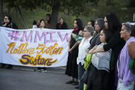 FILE - In this Aug. 29, 2017, file photo Nicole Matthews, second from right, of Minneapolis and her daughter Kiora Burgess-Matthews, attend a prayer circle for Savanna LaFontaine-Greywind at the Ramsey County Medical Examiner's office in St. Paul, Minn. People wore green ribbons to honor Savanna, her favorite color. Interior Secretary Deb Haaland as a former New Mexico congresswoman pushed for a law signed last year to address the crisis of missing, murdered and trafficked Indigenous women. The law, known as Savanna’s Act, is intended to help law enforcement track, solve and prevent crimes against Native Americans, especially women and girls. The law is named for Savanna LaFontaine-Greywind, a member of the Spirit Lake tribe who was abducted and killed in 2017 near Fargo, North Dakota. (Leila Navidi/Star Tribune via AP, File)