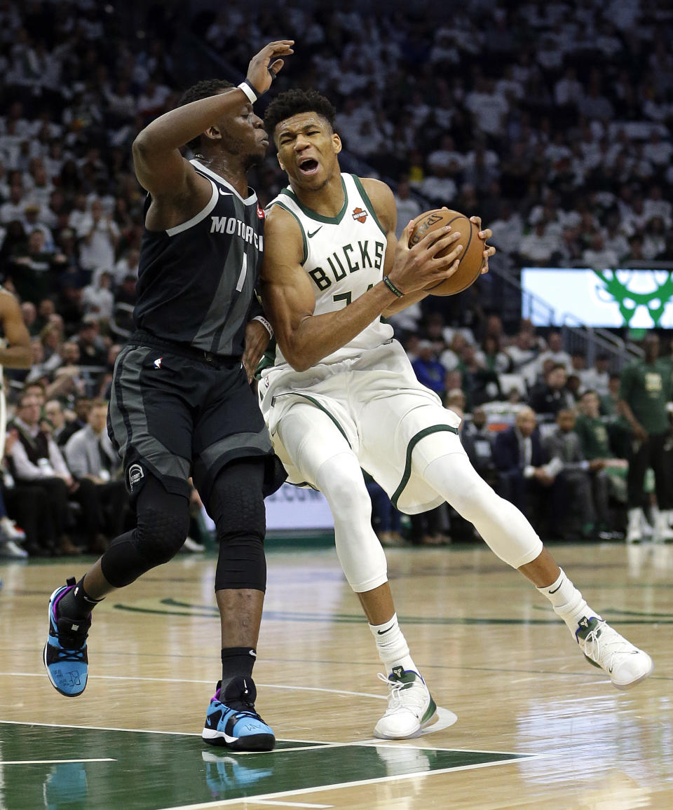 Milwaukee Bucks' Giannis Antetokounmpo drives to the basket against Detroit Pistons' Reggie Jackson during the second half of Game 1 of an NBA basketball first-round playoff series Sunday, April 14, 2019, in Milwaukee. The Bucks won 121-86. (AP Photo/Aaron Gash)