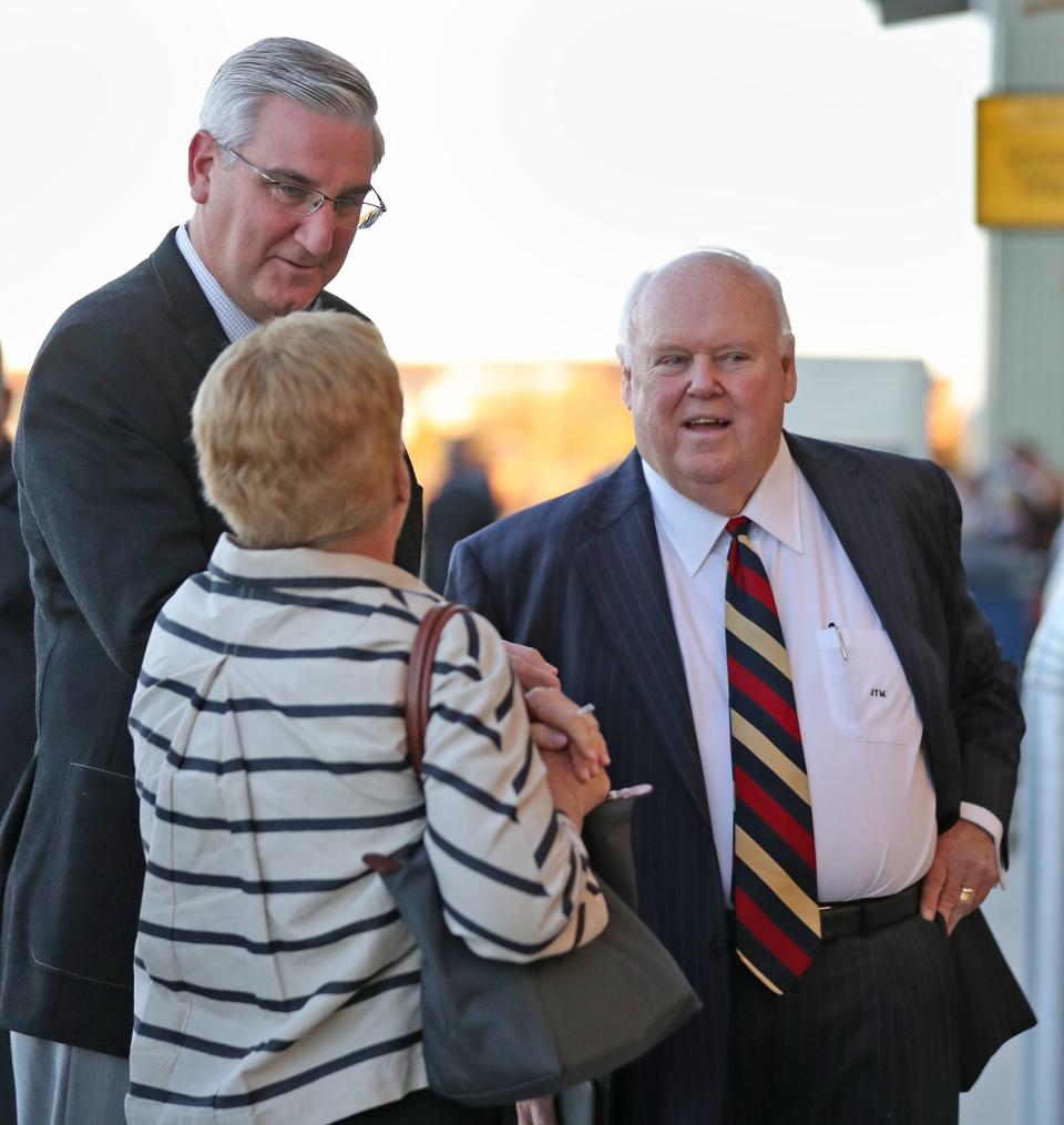 Indiana Gov. Eric Holcomb talks with people, including Jackie and Jim Morris, before the start of the funeral service for P.E. MacAllister, Sunday, Oct. 27, 2019, at MacAllister Machinery Co. headquarters.