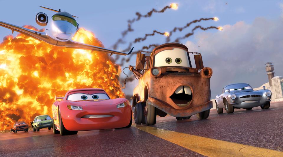 Animated characters Lightning McQueen, voiced by Owen Wilson, foreground left; Mater, voiced by Larry the Cable Guy, center, and Finn McMissile, voiced by Michael Caine, right, are shown in a scene from "Cars 2."