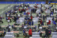 Ballots are counted at the Meadowbank Sports Arena, Magherafelt in Northern Ireland for the 2019 General Election. Thursday Dec. 12, 2019. An exit poll in Britain’s election projects that Prime Minister Boris Johnson’s Conservative Party likely will win a majority of seats in Parliament. That outcome would allow Johnson to fulfil his plan to take the U.K. out of the European Union next month. (Niall Carson/PA via AP)