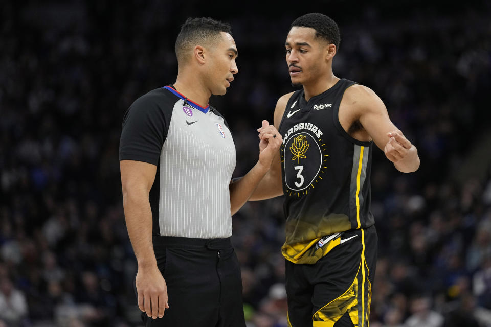 Golden State Warriors guard Jordan Poole (3) speaks with referee John Conley after being called for a foul during the first half of an NBA basketball game against the Minnesota Timberwolves, Wednesday, Feb. 1, 2023, in Minneapolis. (AP Photo/Abbie Parr)