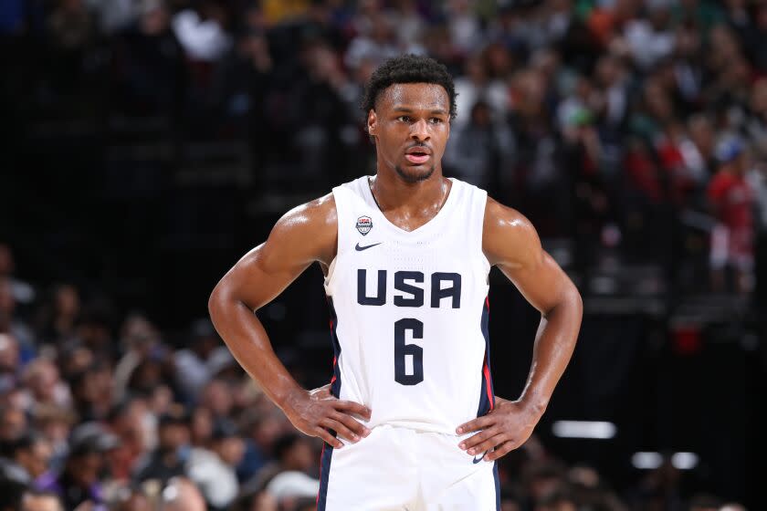 Bronny James wears a Team USA and looks up the court with his hands on his hips.