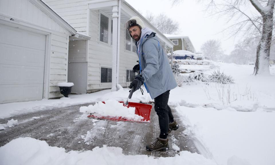 Glen Fuhrmeister shovels a driveway near Woodcrest Drive Tuesday, Jan. 9, 2024 in Iowa City, Iowa.