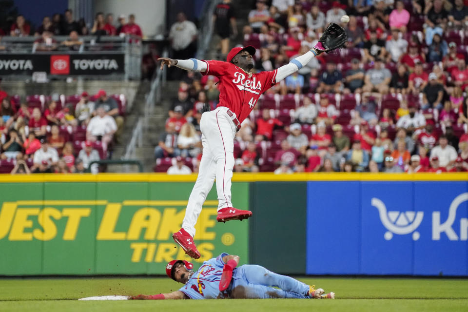 St. Louis Cardinals' Masyn Winn, bottom, steals second base as Cincinnati Reds' Elly De La Cruz, top, misses a throw from catcher Tyler Stephenson during the fourth inning of a baseball game, Saturday, Sept. 9, 2023, in Cincinnati. (AP Photo/Joshua A. Bickel)