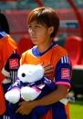 Mana Iwabuchi of Japan holds a bear wearing a shirt in honor of Kozue Ando, who broke her leg in an earlier match, prior to their FIFA Women's World Cup quarter-final match against Australia, at Commonwealth Stadium in Edmonton, on June 27, 2015