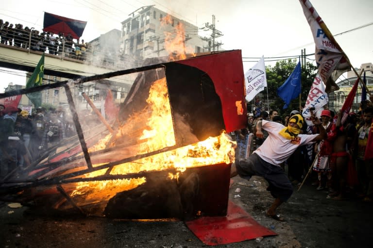 Activists burn an effigy during a protest against Philippine President Rodrigo Duterte near the Malacanang palace in Manila