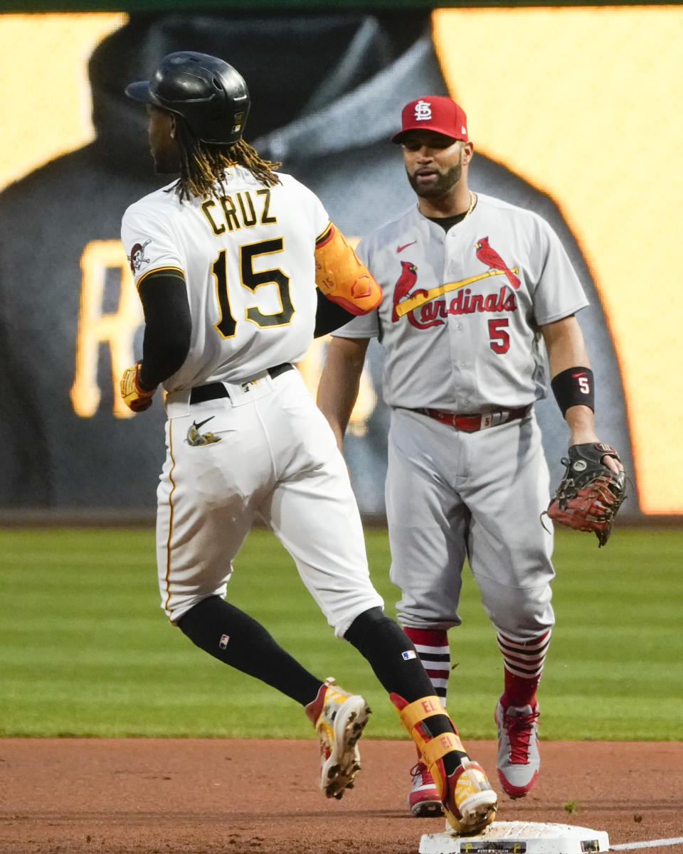 Pittsburgh Pirates' Oneil Cruz (15) steps on first next St. Louis Cardinals first baseman Albert Pujols, after a base hit during the first inning of a baseball game Tuesday, Oct. 4, 2022, in Pittsburgh. (AP Photo/Keith Srakocic)