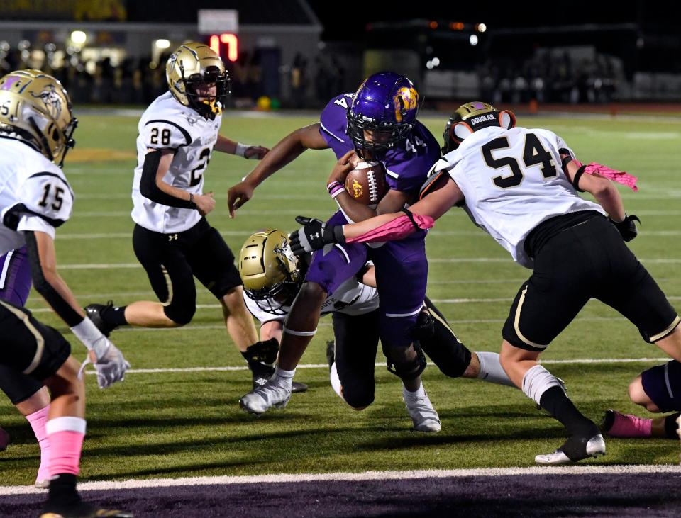 Wylie running back Julius Laine pushes past Lubbock High defensive lineman Harrison Scheppler on his way to a touchdown during the Oct. 22 game at Sandifer Stadium.