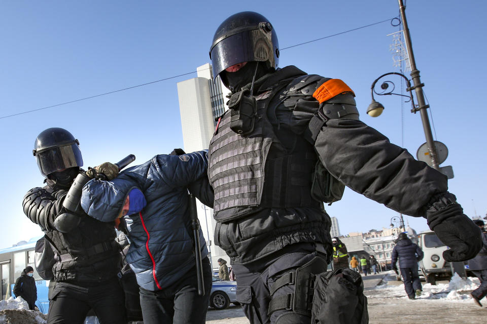 Police officers detain a man during a protest against the jailing of opposition leader Alexei Navalny in Vladivostok, Russia, on Sunday, Jan. 31, 2021. As part of a multipronged effort by the authorities to discourage Russians from attending Sunday's demonstrations, the Prosecutor General's office ordered the state communications watchdog, Roskomnadzor, to block the calls for joining the protests on the internet. (AP Photo/Aleksander Khitrov)