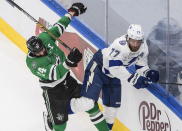 Dallas Stars left wing Jamie Benn (14) checks Tampa Bay Lightning defenseman Victor Hedman (77) during the first period of Game 3 of the NHL hockey Stanley Cup Final, Wednesday, Sept. 23, 2020, in Edmonton, Alberta. (Jason Franson/The Canadian Press via AP)