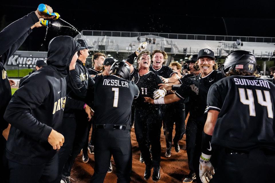 The UCF Knights celebrate a walk-off victory over Texas Tech last week after Andrew Williamson (11) was hit by a pitch, forcing home the game-winning run.