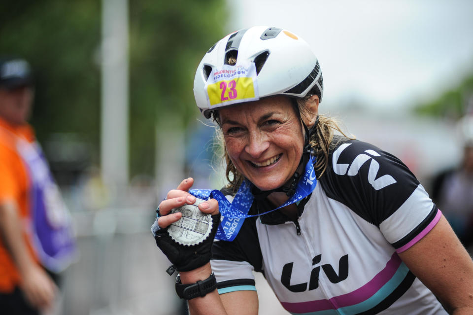 Central London, UK, 29th July 2018. Prudential RideLondon-Surrey 100. BBC Breakfast presenter and GB Team Triathlete, Louise Minchin shows her competitors medal after completing the London - Surrey 100, which sees 26,000 amateur cyclists take on a cycling challenge like no other through London and Surrey on a similar route to that of the London 2012 Olympic road races, as part of the Prudential RideLondon Festival of Cycling weekend. @ David Partridge / Alamy Live News