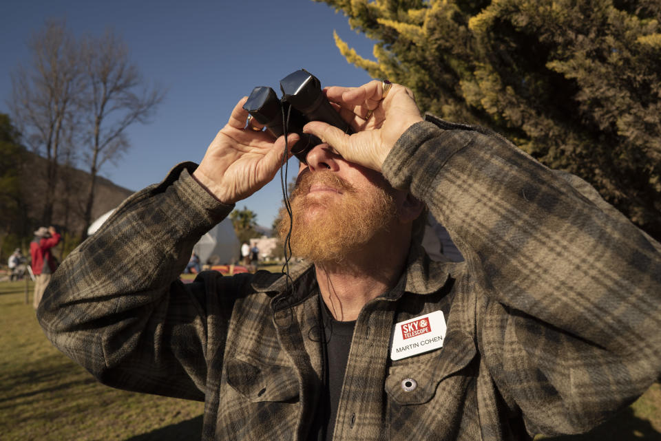 Martin Cohen of Boca Raton, US, watches the total solar eclipse with binoculars with protective solar filters, from El Molle, Chile, July 2, 2019. Tens of thousands of tourists braced Tuesday for a rare total solar eclipse that was expected to turn day into night along a large swath of Latin America's southern cone, including much of Chile and Argentina. (Photo: Stan Honda/AFP/Getty Images)