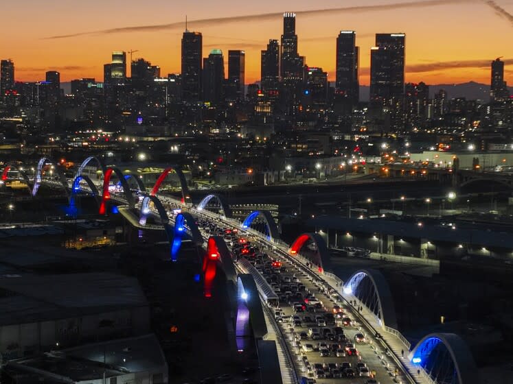 Los Angeles, CA - July 08: After more than six years of construction, Los Angeles officials light the 20 arches dubbed the "Ribbon of Light" on the new 6th Street Viaduct during a ceremony at dusk that begins a three-day community celebration to mark its completion, connecting Boyle Heights and the downtown Arts District and replaces one of the city's structural landmarks. Photo taken 6th Street Viaduct, Los Angeles, CA on Friday, July 8, 2022. The four-lane bridge will connect Boyle Heights and the Arts District across a 3,060 foot-breadth that spans the Los Angeles River, 101 Freeway, railroad tracks and Metrolink tracks. Dubbed the "Ribbon of Light," the $588-million project is considered the most extensive bridge project in the city's history and took six years to complete, with delays due to COVID-19. The event featured a formal ribbon-cutting ceremony at which city officials held a news briefing from L.A. Mayor Eric Garcetti, Councilman De Leon and city engineer Gary Lee Moore. The new viaduct's "Ribbon of Light" design, with its 20 arches, was created by the architectural firm HNTB Corp. and Los Angeles-based architect Michael Maltzan. (Allen J. Schaben / Los Angeles Times)