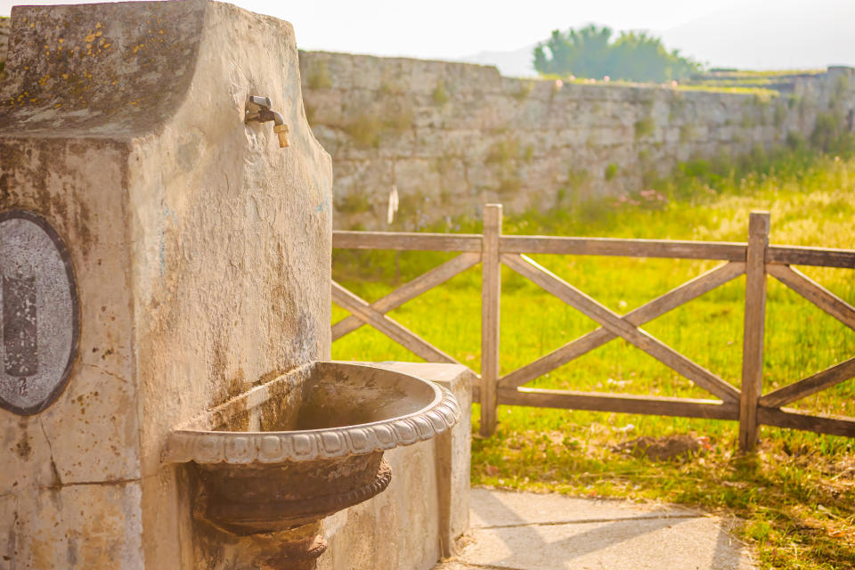 a water fountain made of stone in italy