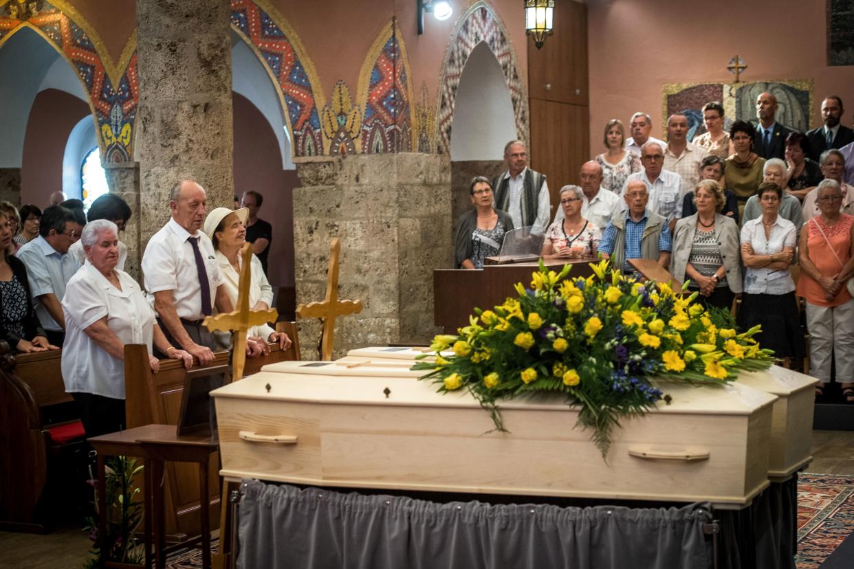 The late couple's daughter, Marcelline Udry, seen third from left, attends her parents' funeral ceremony in Saviese, Switzerland, on Saturday. (Photo: OLIVIER MAIRE via Getty Images)