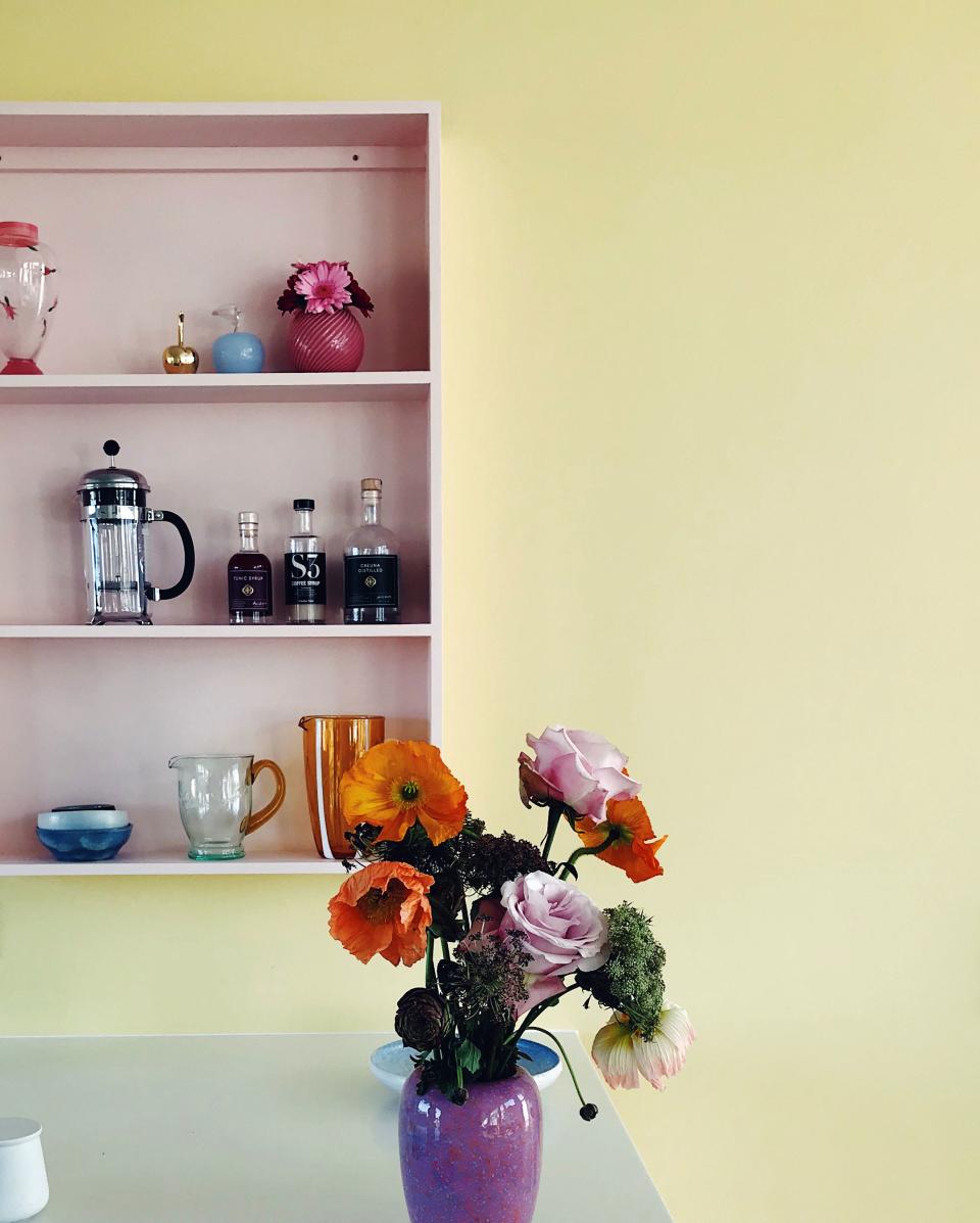 Store the functional, spotlight the pretty: The trick to keeping your kitchen cool, not cluttered? Take a cue from Marie Kondo and only give public real estate to the pieces that bring you joy. “I built this open shelf specifically for this wall to display some nicer things,” Lisbeth says. “It’s a really quick and easy way to add personality.”
A designated spot also allows extra breathing room elsewhere in the space, reducing any sense of visual clutter.