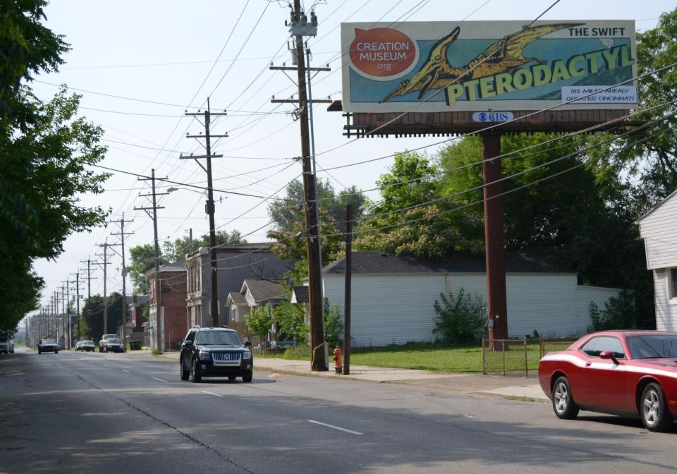 A billboard in Louisville, Ky., shows a new ad campaign for the Creation Museum, on June 11, 2012. A new nationwide billboard ad campaign is using dinosaurs to attract visitors to the Bible-based center near Cincinnati. The museum has exhibits that challenge evolution science and promote a literal interpretation of the Old Testament's creation story. (AP Photo/Dylan Lovan)