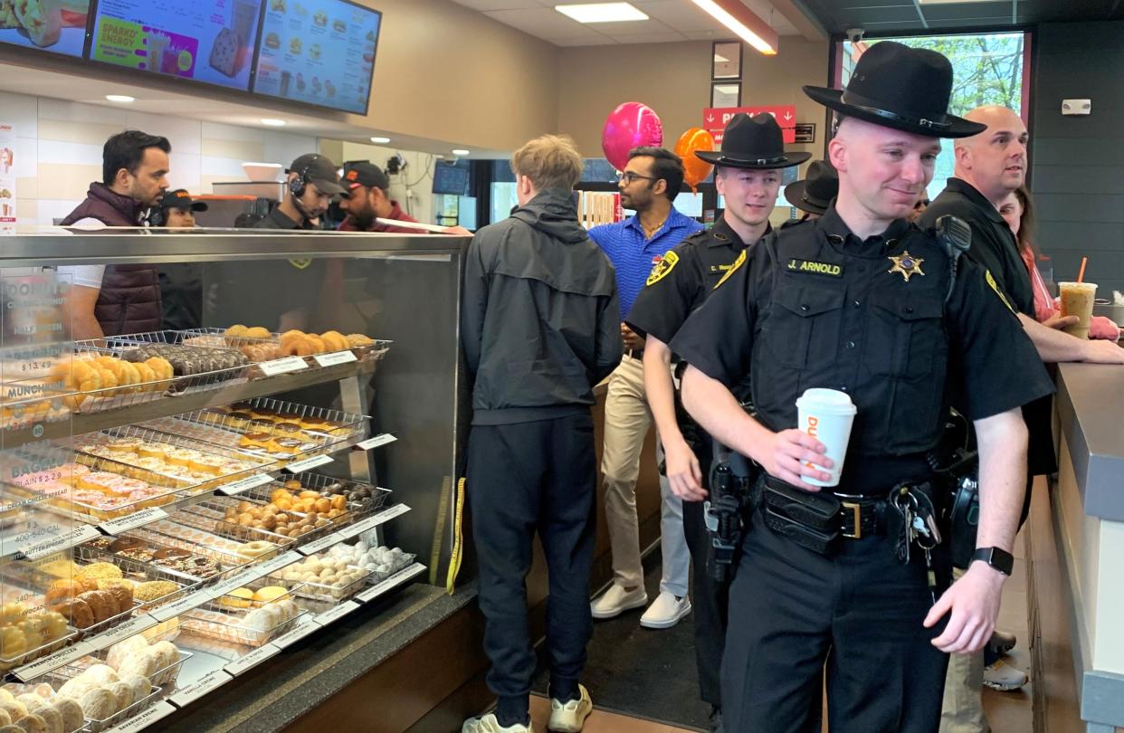 Chemung County sheriff's deputies check out the newly remodeled Dunkin' location on Broadway in Southport on Friday, April 19, 2024. The Southport Dunkin' business donated $1,000 on behalf of injured sheriff's investigator Michael Theetge.