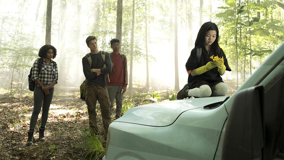 (R) Miya Cech kneels on a car in The Darkest Minds