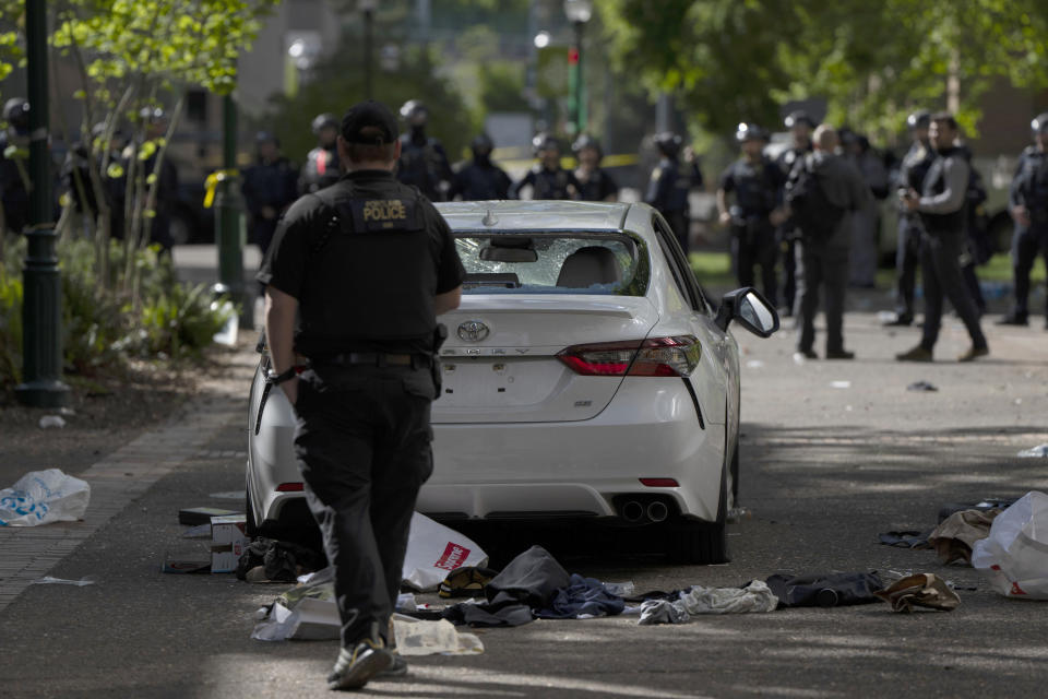 A car that attempted to drive through a crowd of pro-Palestinian protesters on the Portland State University campus is seen parked and damaged on a campus walkway on Thursday, May 2, 2024, in Portland, Ore. After the driver fled on foot, the protesters damaged the car. (AP Photo/Jenny Kane)