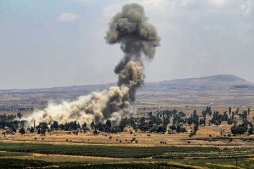 A picture taken from the Israeli-annexed Golan Heights shows smoke rising across the border area in Syria's southwestern Quneitra province on July 22, 2018