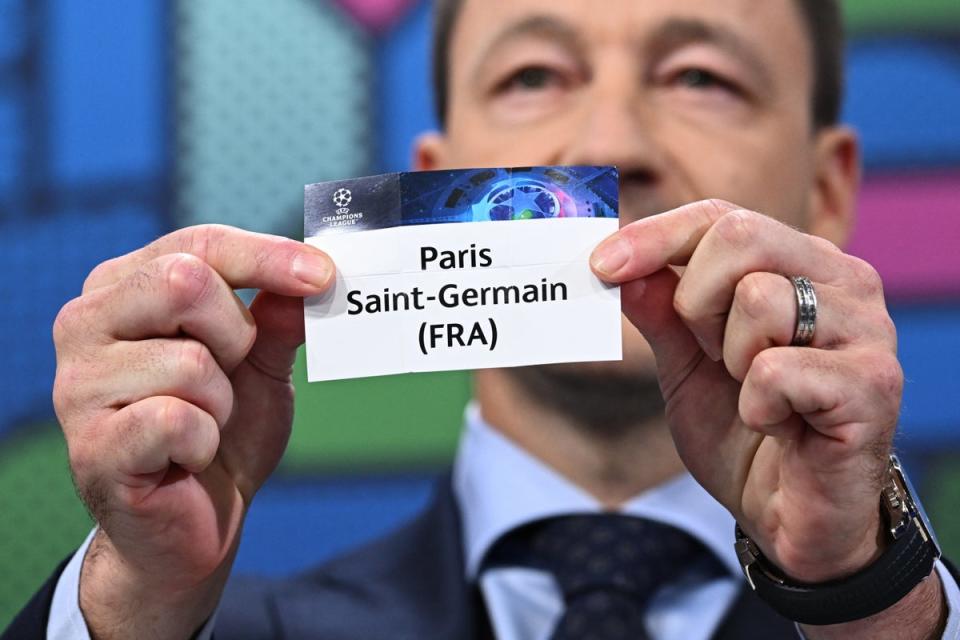 John Terry holds the paper slip of Paris Saint-Germain at the Champions League last 16 draw (Getty)