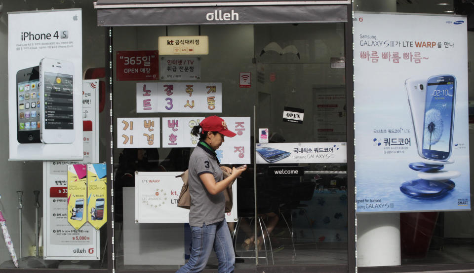 Advertising posters of Samsung Electronics' Galaxy S III, right, and Apple's iPhone 4S, left, are displayed at a mobile phone shop in Seoul, South Korea, Friday, Aug. 24, 2012. The Seoul Central District Court ruled Friday that technology rivals Apple Inc. and Samsung Electronics Co. both infringed on each other's patents, and ordered a partial ban of their products in South Korea. Each side was also ordered to pay limited damages.(AP Photo/Ahn Young-joon)