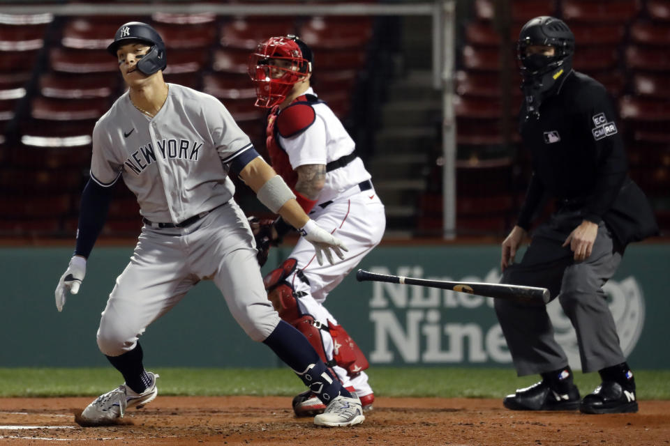 New York Yankees' Aaron Judge, left, grounds into a double play in front of Boston Red Sox's Christian Vazquez during the third inning of a baseball game Friday, Sept. 18, 2020, in Boston. (AP Photo/Michael Dwyer)