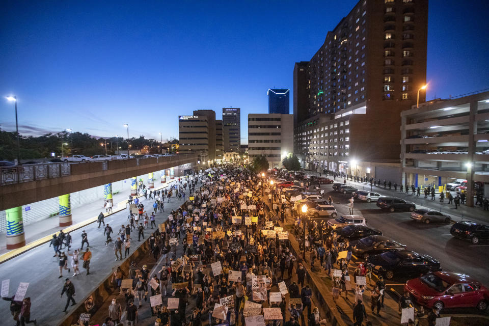 Protesters walk down East Vine Street in Lexington, Ky., during a rally against the deaths of George Floyd and Breonna Taylor on Sunday, May 31, 2020. (Ryan C. Hermens/Lexington Herald-Leader via AP)