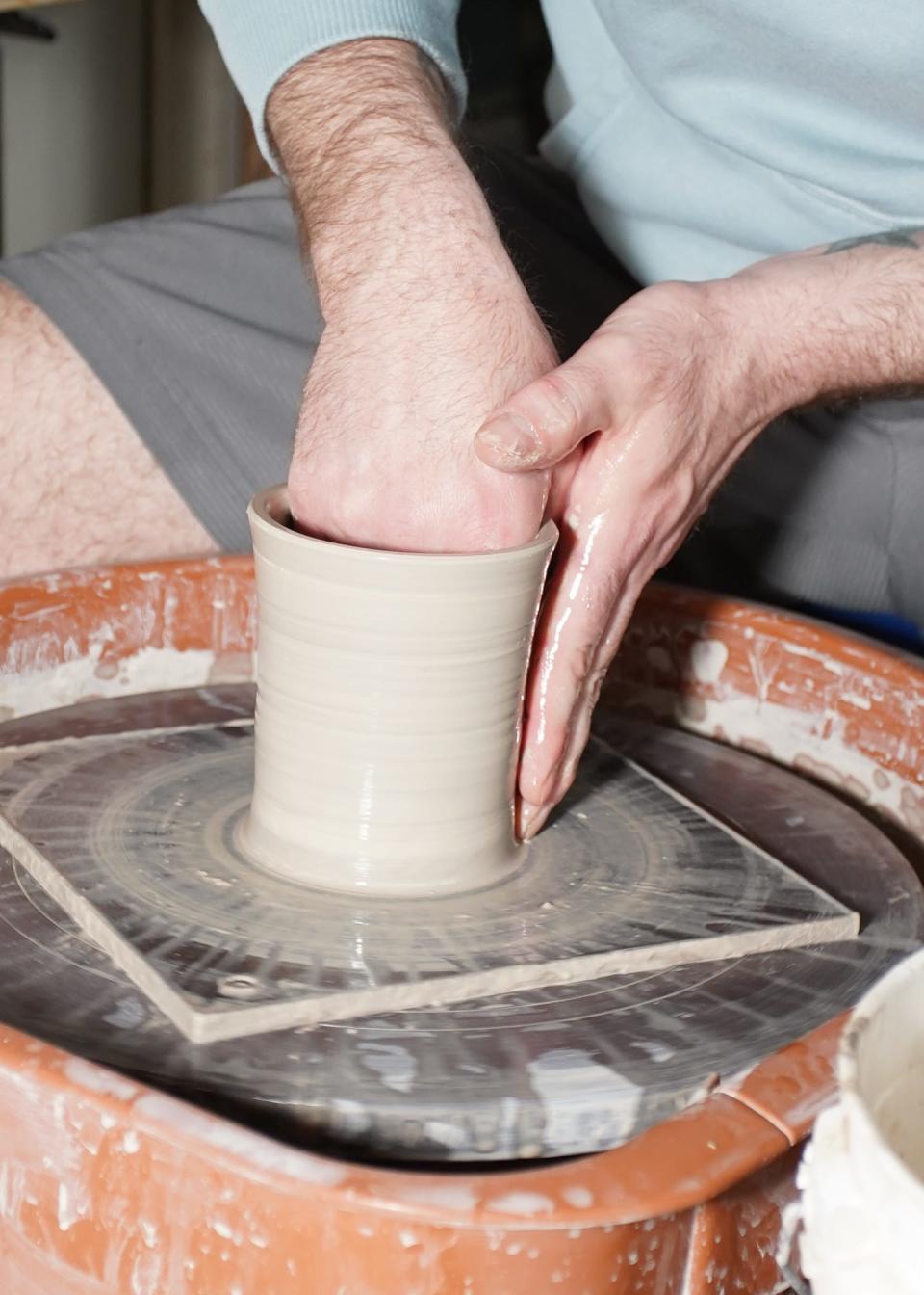 Justin Jones makes a piece of pottery.