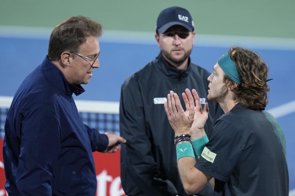 FILE - ATP Supervisor Roland Herfel, left, disqualifies Andrey Rublev during his semifinal match with Alexander Bublik of Kazakhstan at the Dubai Duty Free Tennis Championships in Dubai, United Arab Emirates, Friday, March 1, 2024. Rublev appealed his default and the ATP ruled Monday, March 4, he will be allowed to keep his rankings points and prize money from the tournament, minus a $36,400 fine for unsportsmanlike conduct after he appealed the punishment of his default from the semifinals for yelling in the face of a line judge last week. (AP Photo/Kamran Jebreili)