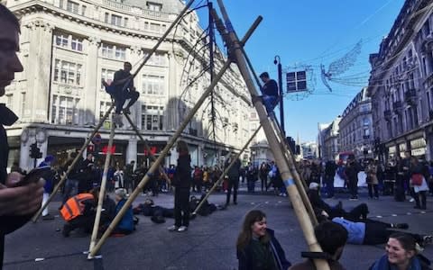 Extinction Rebellion block Oxford Circus in central London with giant bamboo structure - Credit: Sam Povey