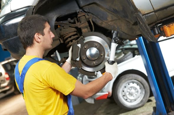 car mechanic examining car...