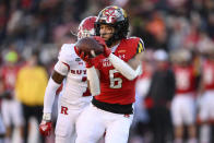 Maryland wide receiver Jeshaun Jones (6) makes a catch en route to scoring a touchdown during the second half of an NCAA college football game past Rutgers defensive back Robert Longerbeam (7) Saturday, Nov. 26, 2022, in College Park, Md. Maryland won 37-0. (AP Photo/Nick Wass)