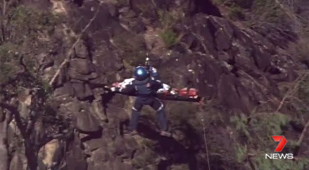 The woman has now been winched into the helicopter. Source: 7News
